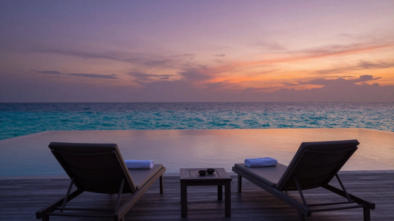 Quiet boutique infinity pool overlooking the ocean during a colorful sunset.